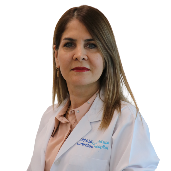 Portrait of a female doctor in a white coat with a pink blouse, Emirates Hospital logo visible, neutral expression, light background.
