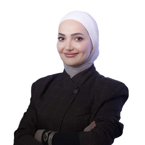 Professional woman wearing a white hijab and dark plaid blazer, arms crossed, smiling at the camera.