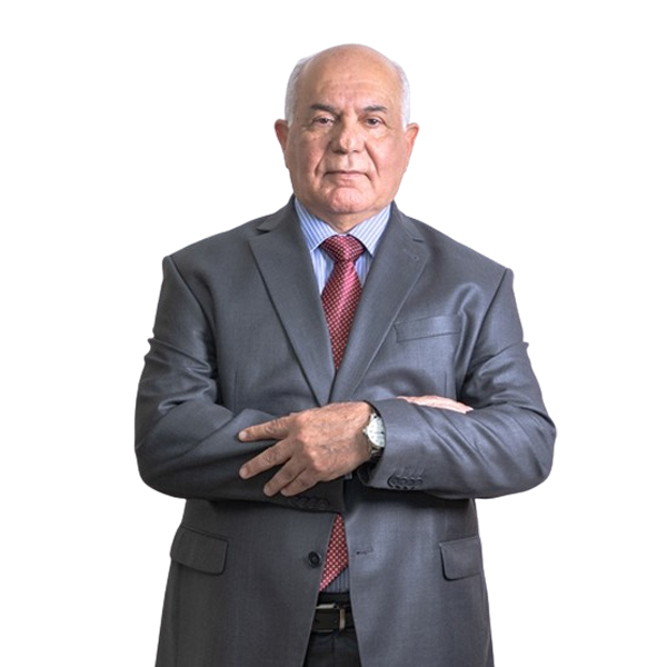 Senior businessman in a gray suit with a red tie, arms crossed, looking at the camera.